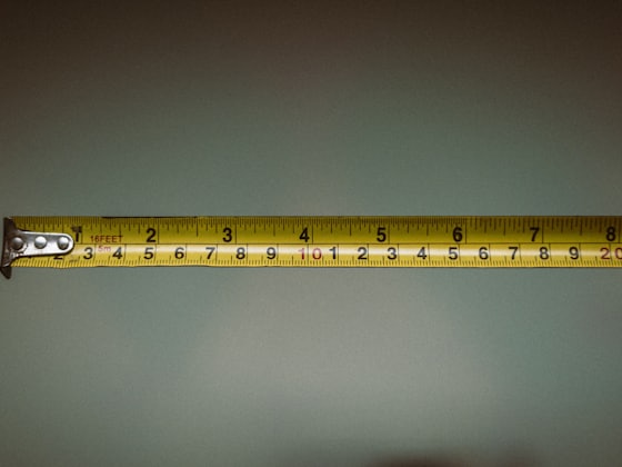 A tape held against the wall during the survey