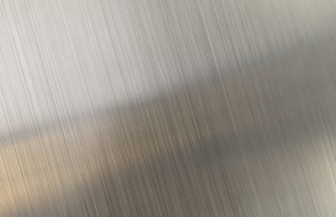 Brushed metal surface with fine vertical grain
